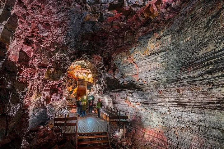 Group with headlamps inside the Raufarholshellir lava tunnel on an Iceland volcano tour