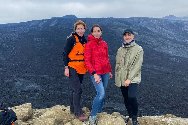 Coach group walking a cooled eruption site on a Reykjanes Iceland volcano tour from Reykjavik